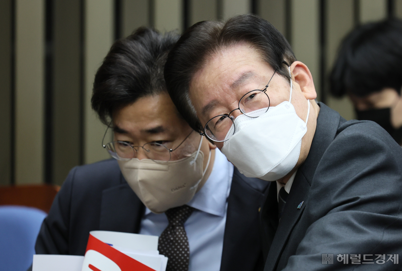 이재명(오른쪽) 더불어민주당 대표가 김용 민주연구원 부원장 구속 후 국회에서 열린 긴급 의원총회에 참석해 회의 시작에 앞서 박찬대 최고위원과 이야기를 나누고 있다. 이상섭 기자