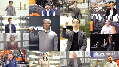 현대두산인프라코어가 27일 공개한 새 브랜드 ‘디벨론(DEVELON)’ 쇼케이스 영상의 한 장면. 조영철(가운데 오른쪽) 현대두산인프라코어 사장과 오승현(가운데 왼쪽) 현대두산인프라코어 대표, 글로벌 직원 12명이 “위 아 디벨론(We are Develon)”을 외치고 있다.[현대두산인프라코어 유튜브]