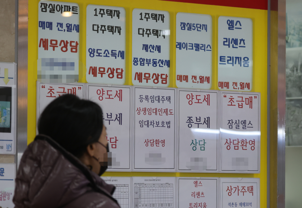 서울 한 부동산중개사무소 앞을 시민이 지나가고 있다.[연합]