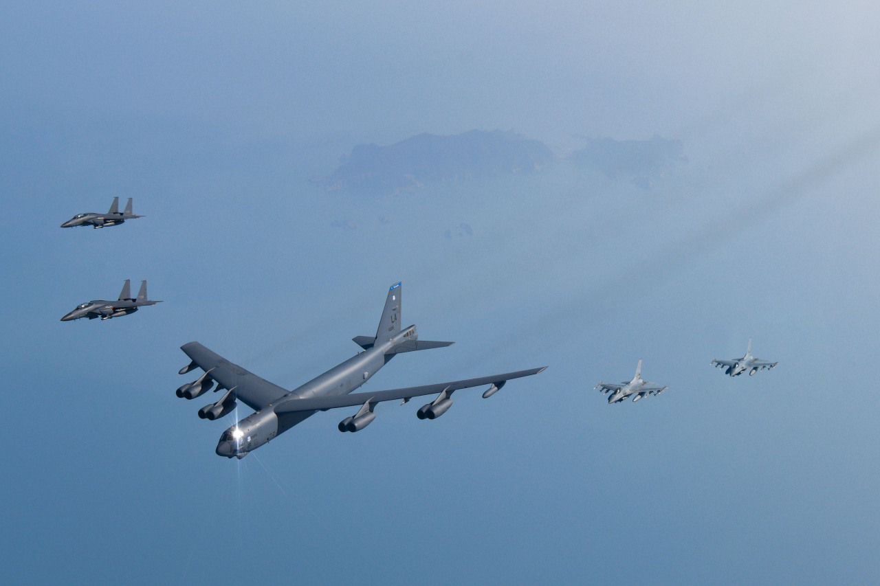 A U.S. nuclear-capable B-52H strategic bomber (C), alongside F-15K and KF-16 jet fighters of South Korea, fly in formation over the Yellow Sea on March 6, 2023, as the allies staged combined air drills against North Korea`s evolving military threats. (Photo - Defense Minsitry)