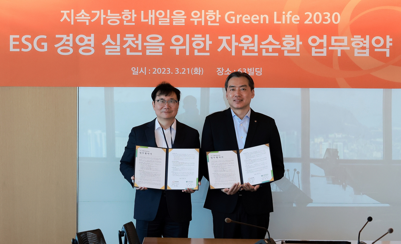 한화생명과 E-순환거버넌스가 지난 21일 서울 여의도 63빌딩에서 ESG경영 실천을 위한 자원순환 업무협약을 체결한 자리에서 정영호(오른쪽) 한화생명 성장경영추진실장과 정덕기 E-순환거버넌스 이사장이 기념사진을 촬영하고 있다. [한화생명 제공]