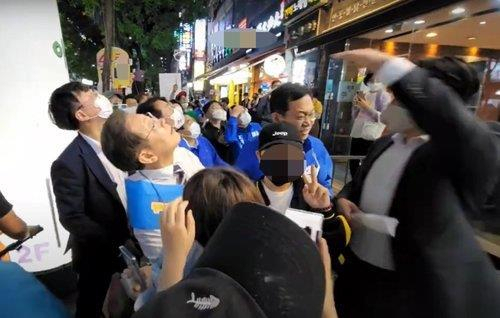건물 위에서 철제그릇이 떨어지자 쳐다보는 이재명 당시 계양을 국회의원 후보. [유튜브 채널 이재명 캡처]