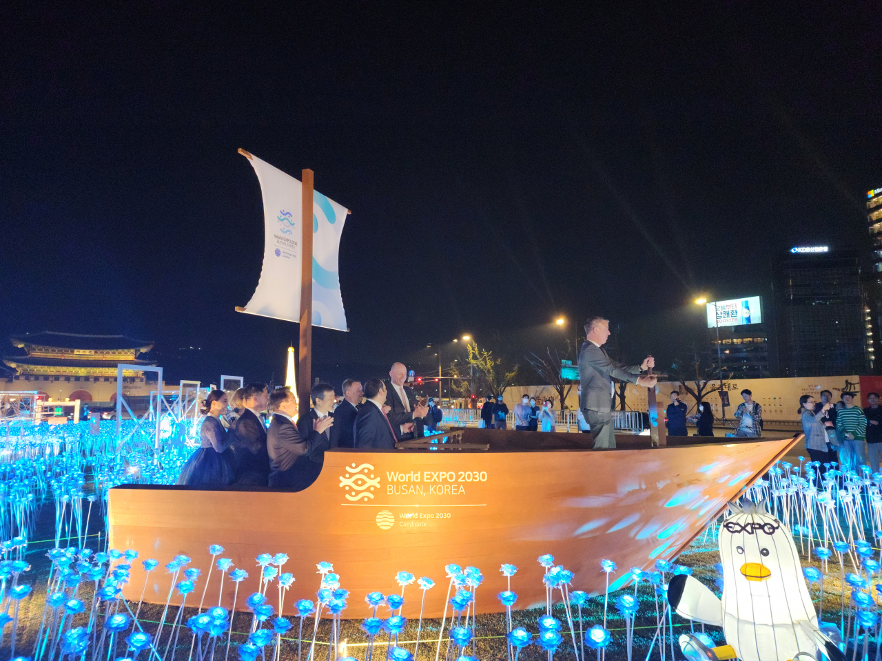 Members of BIE take a ride a ship that symbolizes "the voyage of hope for the Expo," and Manuel Salchli, Swiss representative of the BIE, spins the helm in Gwanghwamun Plaza, Monday. (Lee Yoon-seo/The Korea Herald)