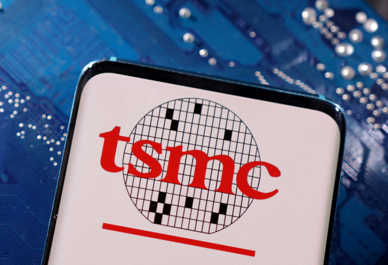FILE PHOTO: A smartphone with a displayed TSMC (Taiwan Semiconductor Manufacturing Company) logo is placed on a computer motherboard in this illustration taken March 6, 2023. REUTERS/Dado Ruvic/Illustration/File Photo