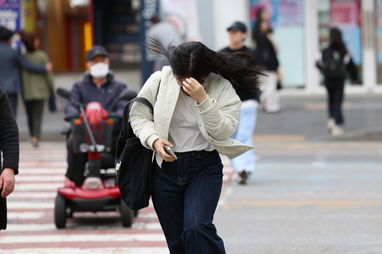 전국에 강풍특보가 내려진 11일 광주 북구 전남대학교 인근 도로에서 행인들이 바람을 맞으며 횡단보도를 건너고 있다. [연합]