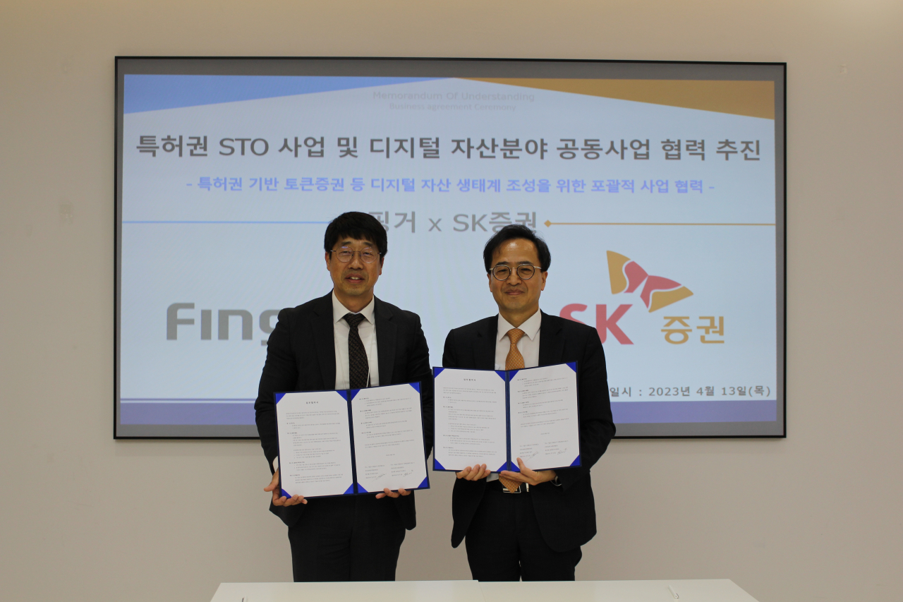 안인주(왼쪽) 핑커 대표와 최석원 SK증권 미래전략부문 대표가 STO 사업협력을 위한 업무협약(MOU)식에서 기념촬영을 하고 있다. [SK증권]