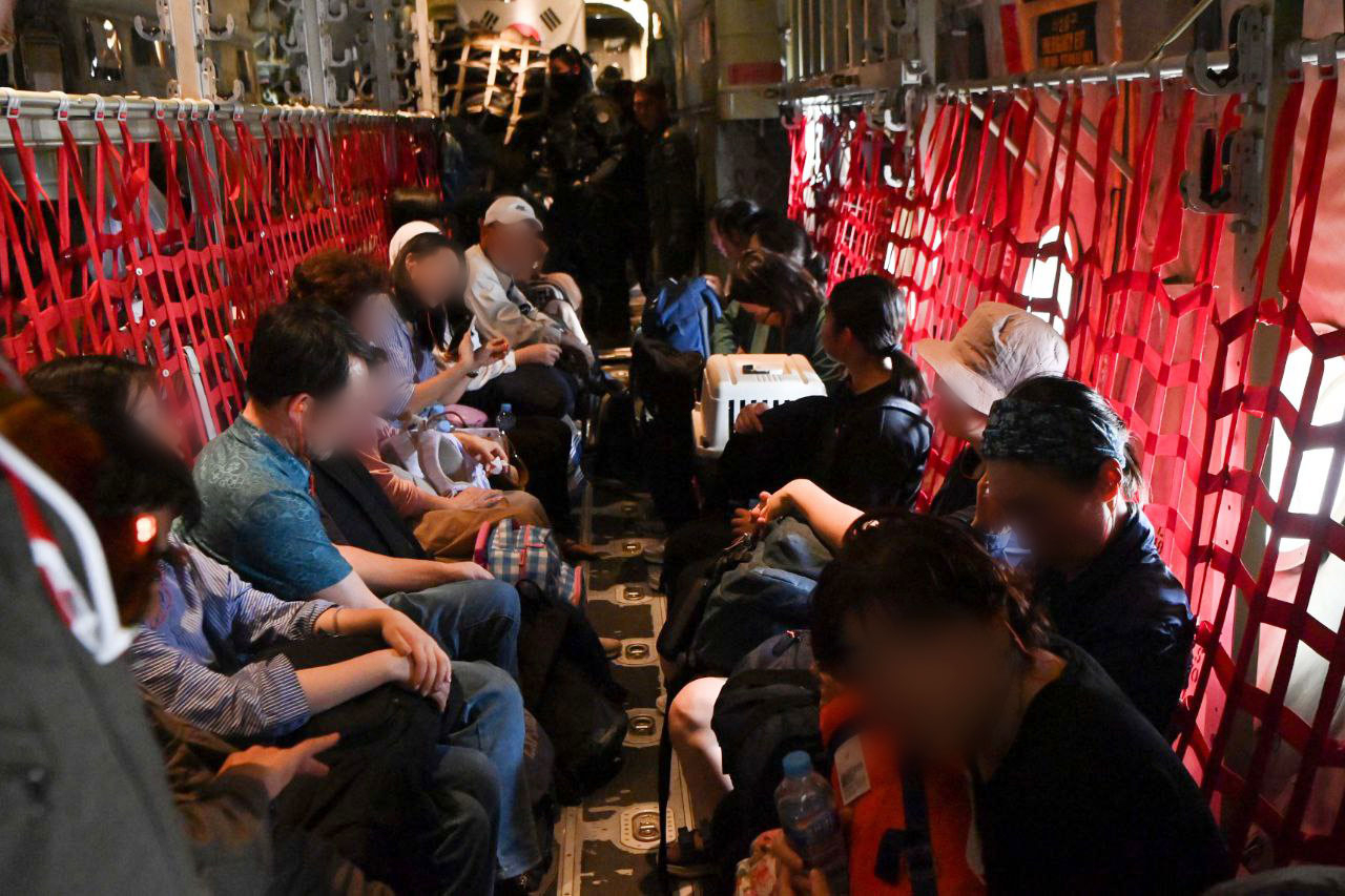 Korean nationals are pictured aboard a military aircraft en route to Jeddah International Airport in Saudi Arabia after being evacuated from strife-torn Sudan in this photo released by South Korea's Foreign Ministry, Tuesday. (Yonhap)