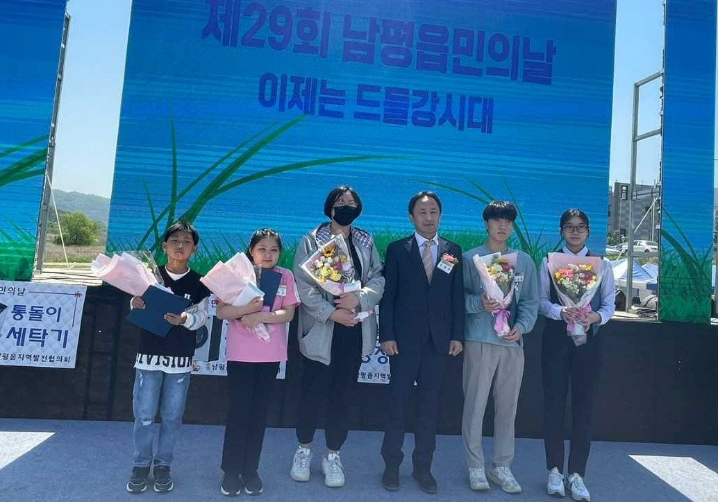 지난달 30일 열린 ‘제29회 남평읍민의 날’ 행사에서 임대형(왼쪽 네번째) 골드레이크컨트리클럽 대표와 장학생들이 기념 촬영을 하고 있다.