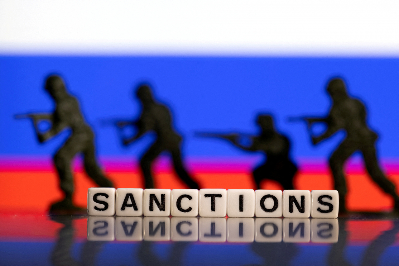 Solider toys are placed in front of Russia's flag colors in an illustration (Reuters)