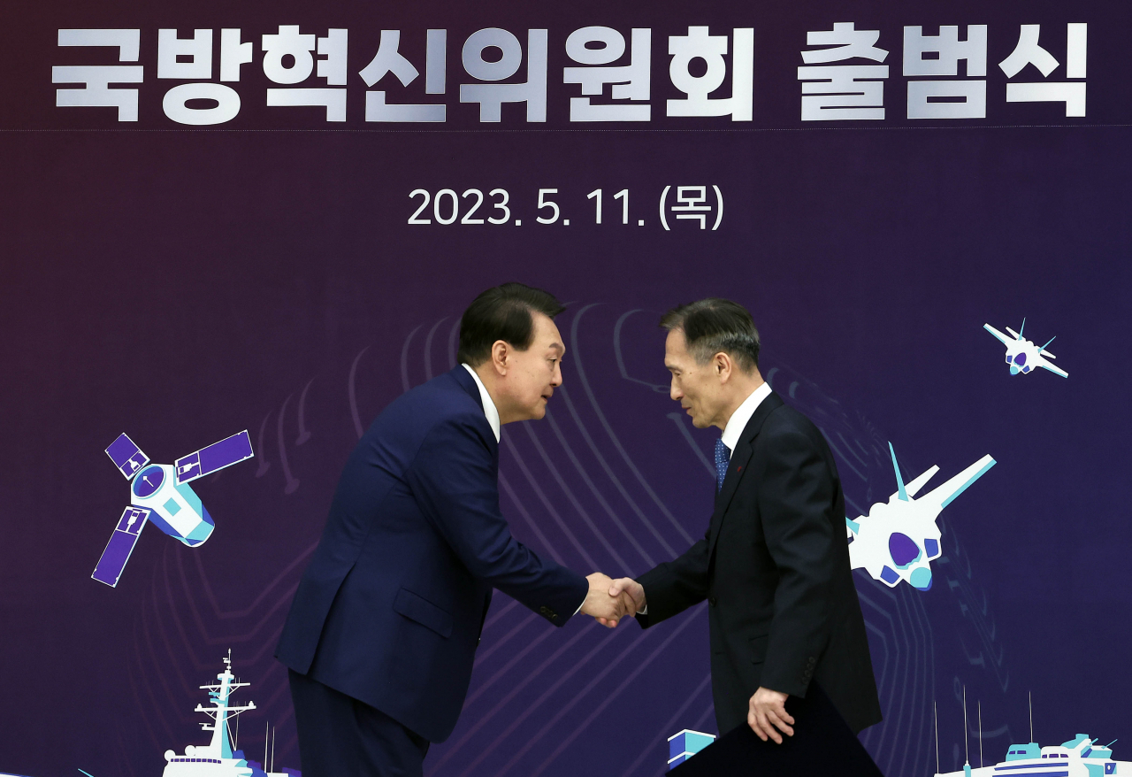 윤석열 대통령이 11일 서울 용산 대통령실 청사에서 열린 대통령 직속 국방혁신위원회 출범식에서 김관진 전 국방부 장관에게 위촉장을 수여한 뒤 악수하고 있다. [연합]