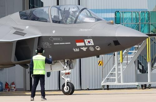 A prototype of the KF-21 fighter jet under development bearing the flags of South Korea and Indonesia moves out of a hangar at the headquarters of Korea Aerospace Industries Ltd. in Sacheon, 437 kilometers south of Seoul, on May 9. (Yonhap)