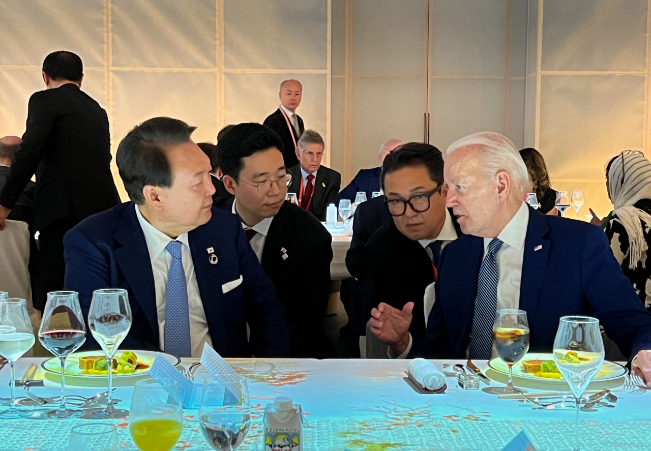 윤석열 대통령이 지난 20일 오후 일본 히로시마 그랜드 프린스 호텔에서 열린 G7 정상회의 친교 만찬에서 조 바이든 미국 대통령과 대화하고 있다. [연합]