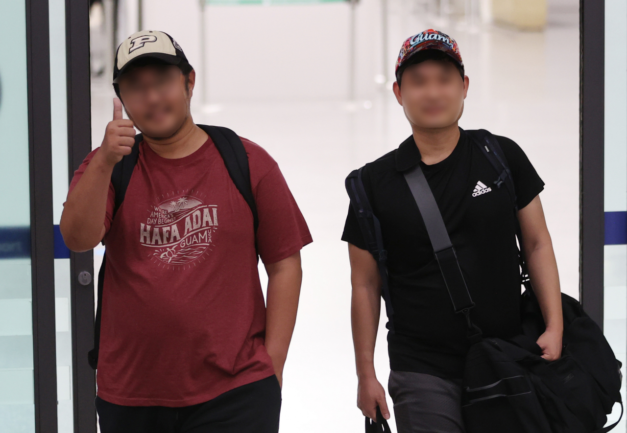 괌을 강타한 태풍 '마와르'로 인해 현지에 발이 묶였던 한국 관광객둘이 괌 국제공항 운영 재개로 29일 오후 인천국제공항 제1여객터미널을 통해 입국하며 엄지를 들어올리고 있다. [연합]