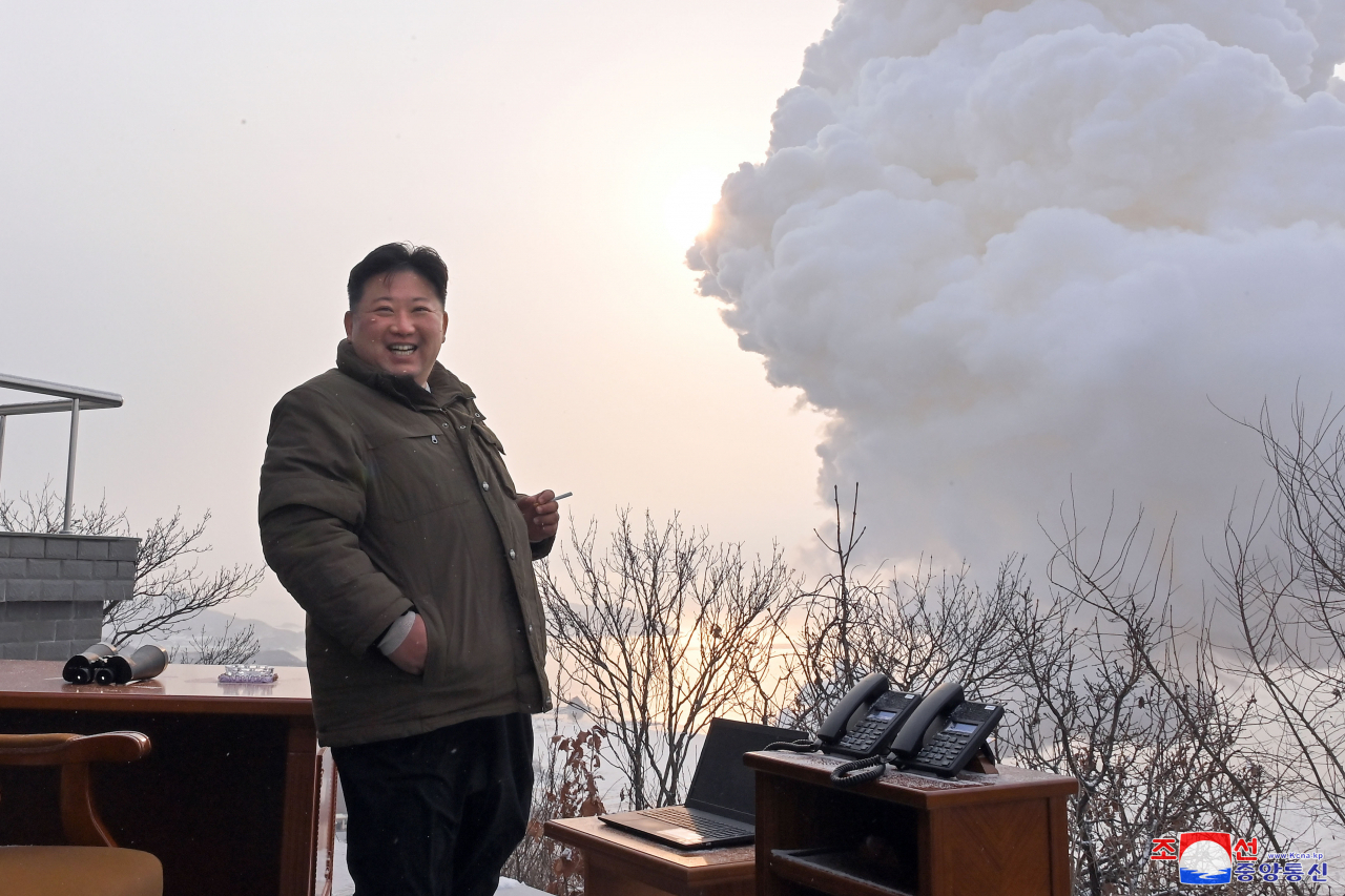 North Korean leader Kim Jong-un smiles contently after watching a ground test of a "high-thrust solid-fuel motor" at Sohae Satellite Launching Ground in Cholsan, North Pyongan Province, North Korea, on Dec. 15, 2022. (KCNA)