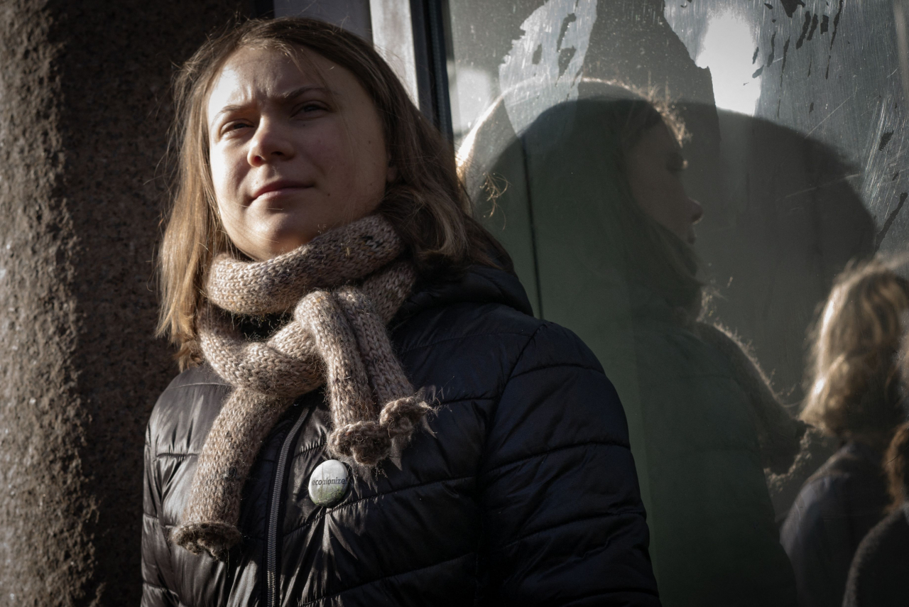 (FILES) A photo taken on February 28, 2023 shows Swedish climate activist Greta Thunberg next young climate protesters from the
