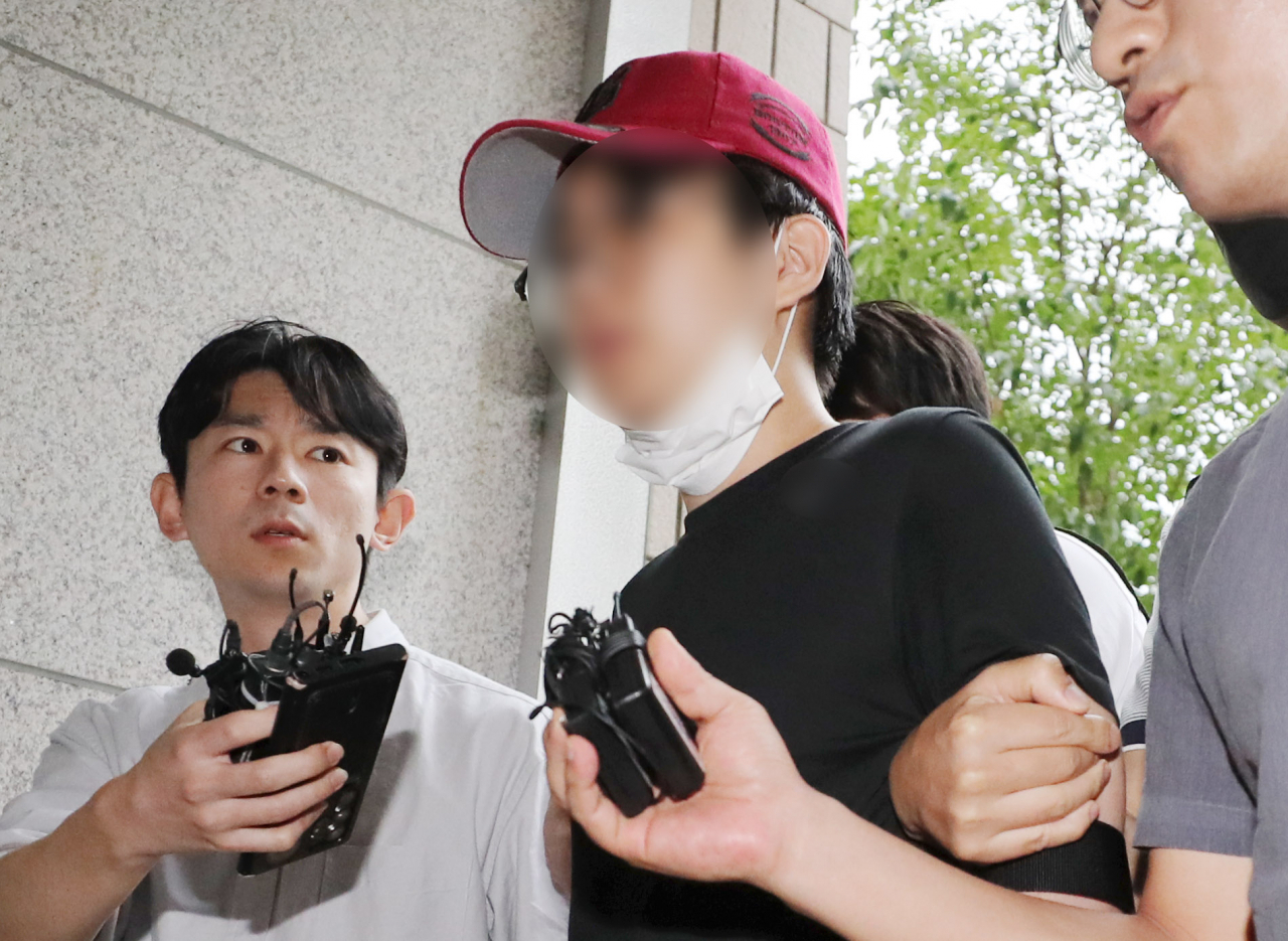 인천국제공항으로 향하던 여객기에서 비상문을 열려고 한 혐의를 받는 10대 남성이 20일 오후 구속 전 피의자 심문(영장실질심사)을 받기 위해 인천지법으로 들어서고 있다. [연합]