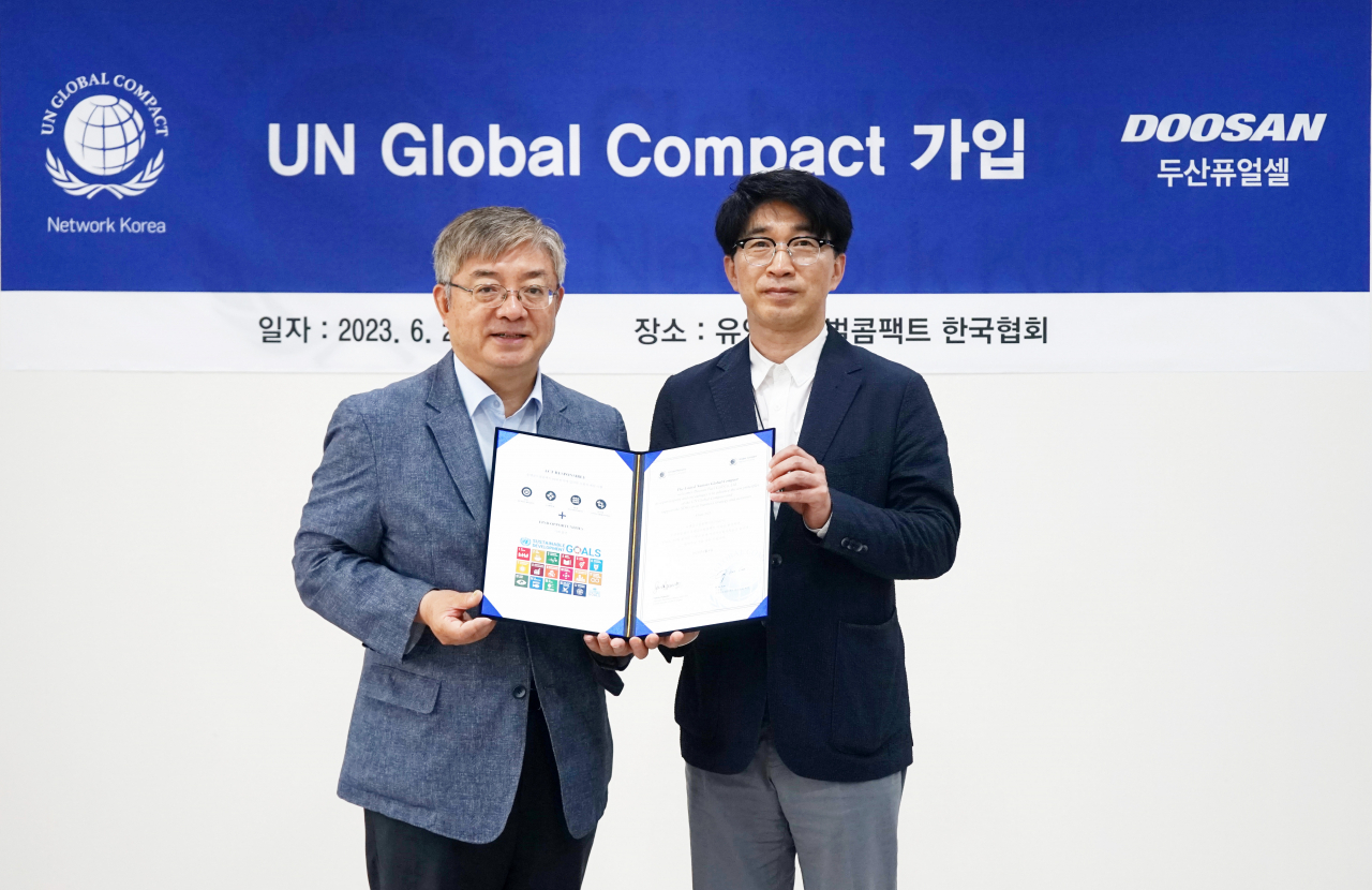 박준영(오른쪽) 두산퓨얼셀 전무와 유연철 UNGC 사무총장이 기념사진을 촬영하고 있다. [두산퓨얼셀 제공]