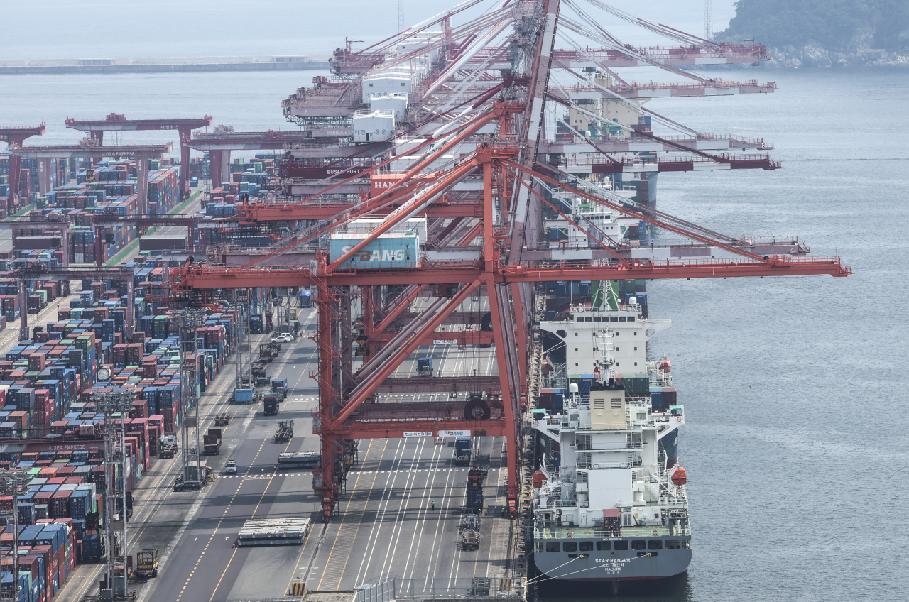 Containers for exports and imports are stacked at a pier under an overcast sky in South Korea's largest port city of Busan, southeastern South Korea, in this file photo taken June 12. (Yonhap)
