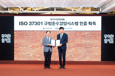 함윤식(오른쪽) 우아한형제들 고객중심경영부문장과 한국준법진흥원 황인학 원장이 기념 촬영을 하고 있다. [우아한형제들 제공]