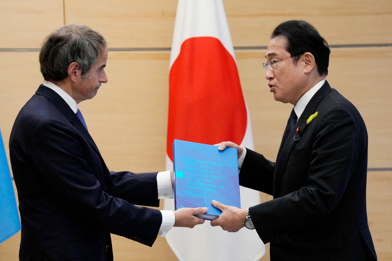 4일 라파엘 그로시 국제원자력기구(IAEA) 사무총장(왼쪽)이 일본 도쿄 총리관저에서 기시다 후미오 총리에게 후쿠시마 제1원전 오염수 방류의 안전성에 대한 최종 보고서를 전달하고 있다. [AFP]