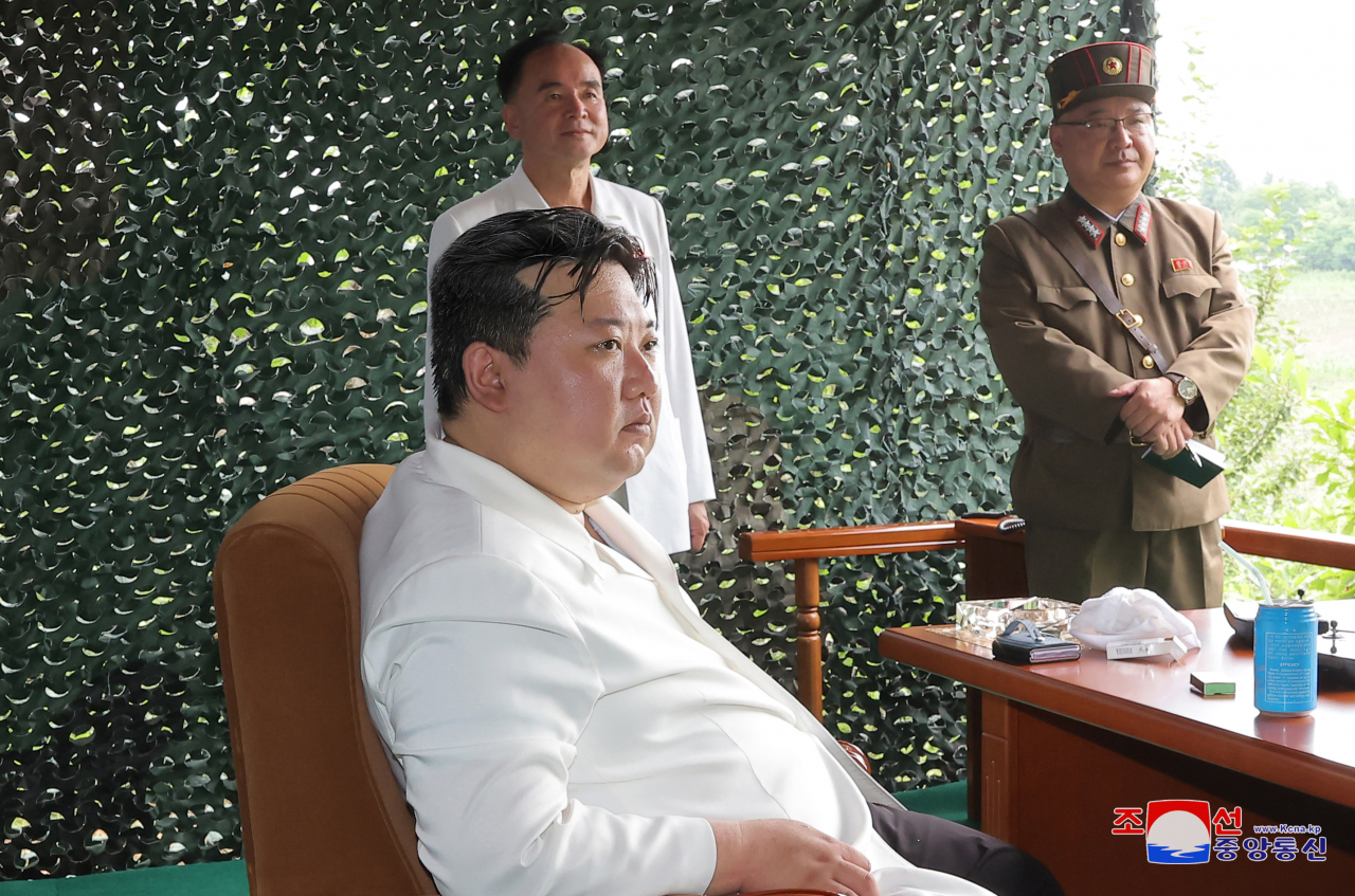 North Korean leader Kim Jong-un (front) inspects the launch of a Hwasong-18 solid-fuel intercontinental ballistic missile (ICBM) on Wednesday, in this photo released by North Korea's state-run Korean Central News Agency. (Yonhap)