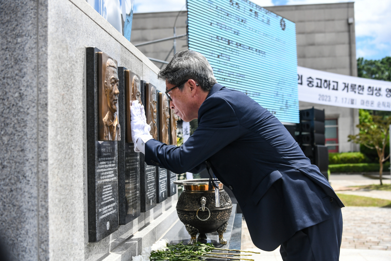 순직 장병 유가족(故노동환 중령 부친)이 헌화 및 분양 후 위령탑에 새겨진 부조상을 어루만지고 있다.[해병대 제공]