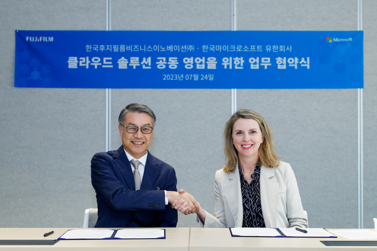 지난 24일 한국후지필름BI 하토가이 준 대표와 한국마이크로소프트 아시아 지역 레이첼 본디 SMC 부문 기업 부사장이 업무 협약서에 서명한 뒤 악수하고 있다. [한국후지필름BI 제공]