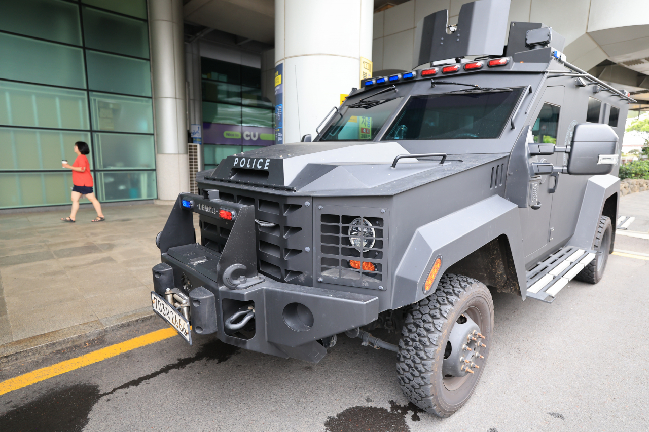 A special police squad and a police tank patrol Jeju International Airport on Sunday. (Yonhap)