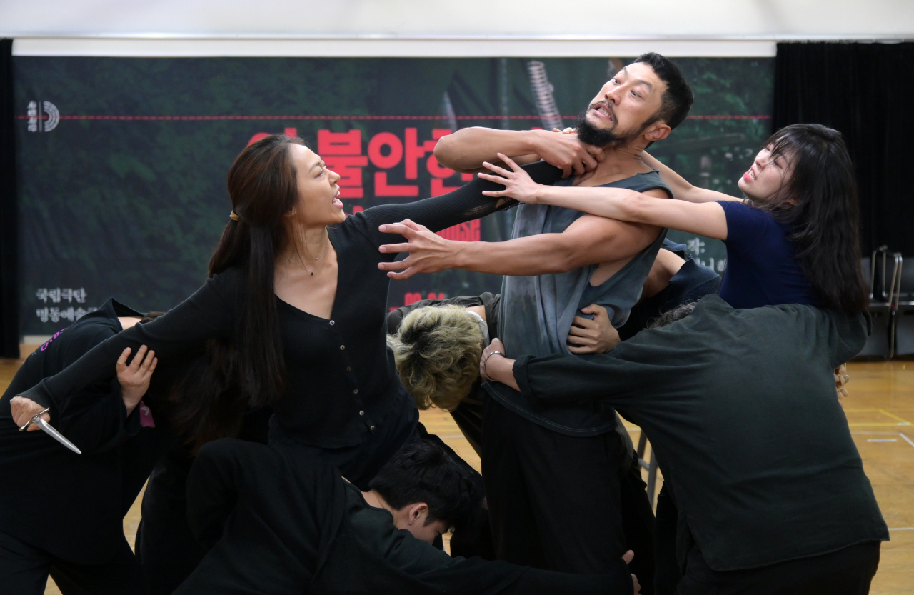 Actors rehearse a scene from "This Restless House" during a press conference held in Seoul, Friday. (NTCK)