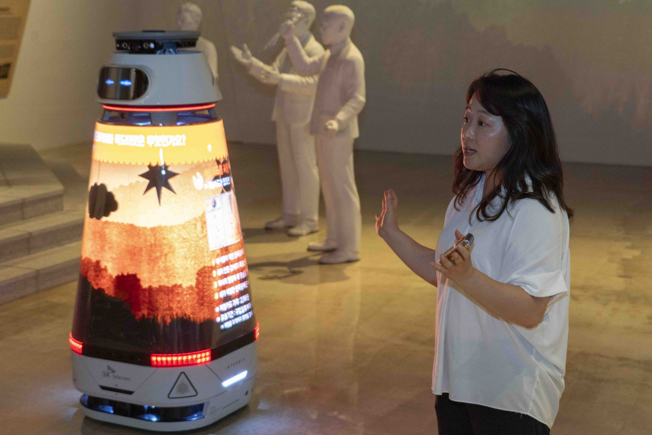 The AI media robot Nuri, powered by OpenAI‘s ChatGPT, moves around the exhibition space to explain the independence movement to visitors at the Independence Hall of Korea. (SK Telecom)