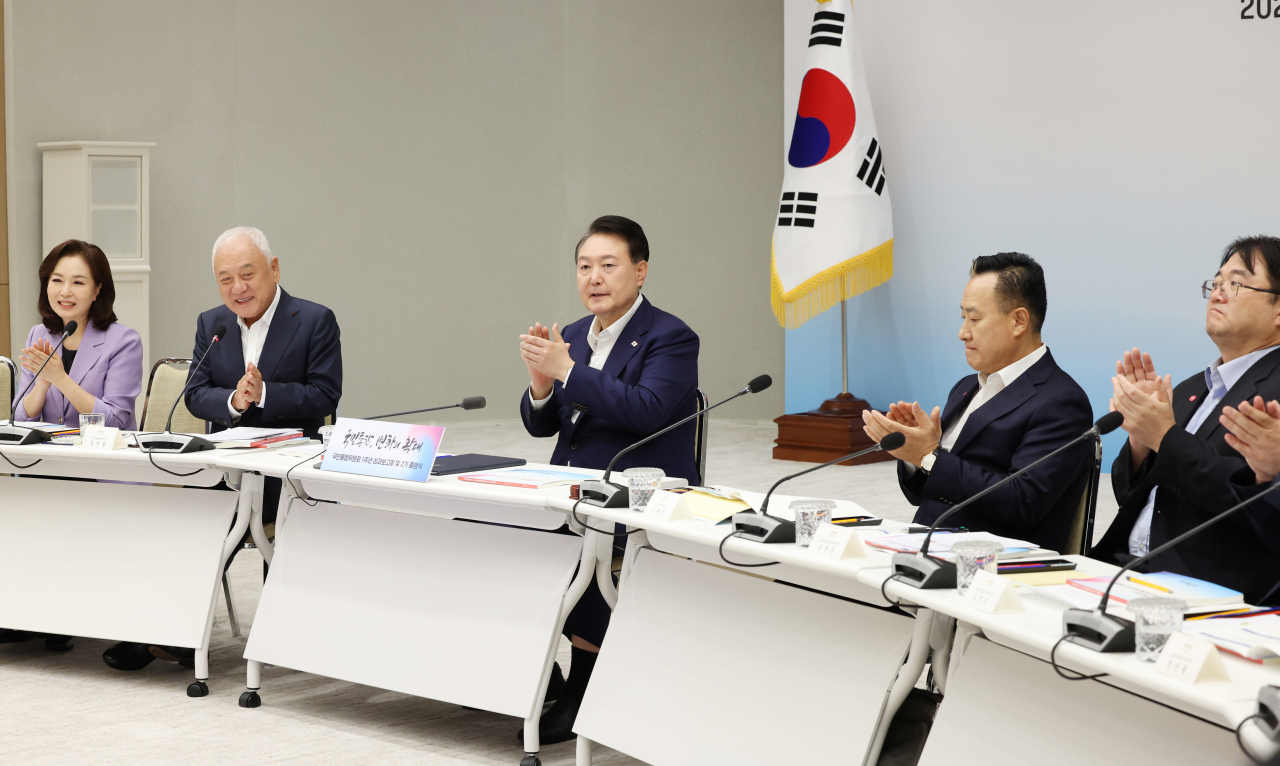 윤석열 대통령이 25일 서울 용산 대통령실 청사에서 열린 국민통합위원회 1주년 성과보고회 및 2기 출범식에서 발언을 마친 뒤 김한길 국민통합위원회 위원장 등으로부터 박수받고 있다. [연합]
