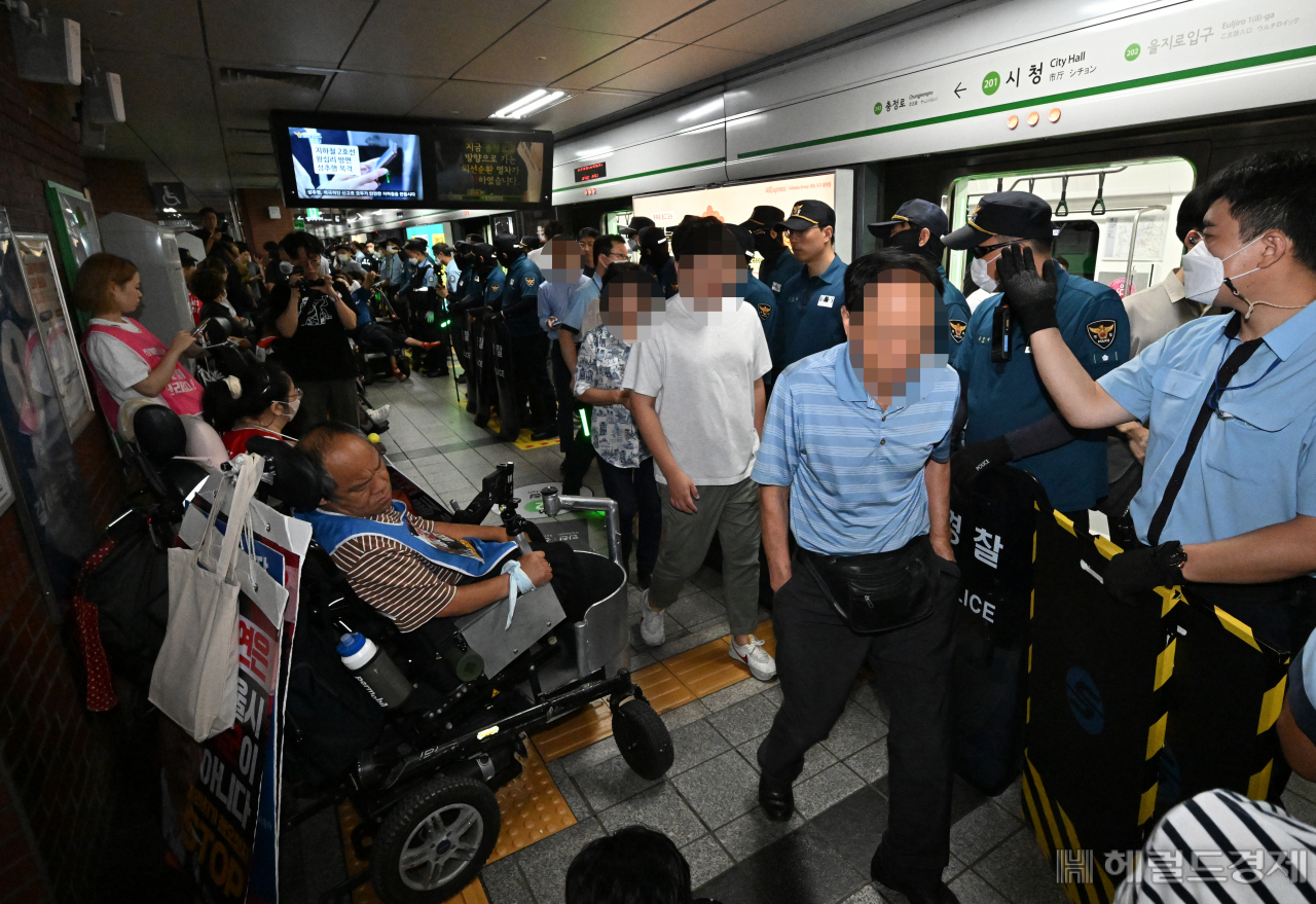 전국장애인차별철폐연대(전장연)가 약 8개월 만에 지하철 출근길 시위를 재개한 가운데 11일 서울 중구 지하철2호선 시청역 플랫폼에서 시민들이 하차해 이동하고 있다. 임세준 기자