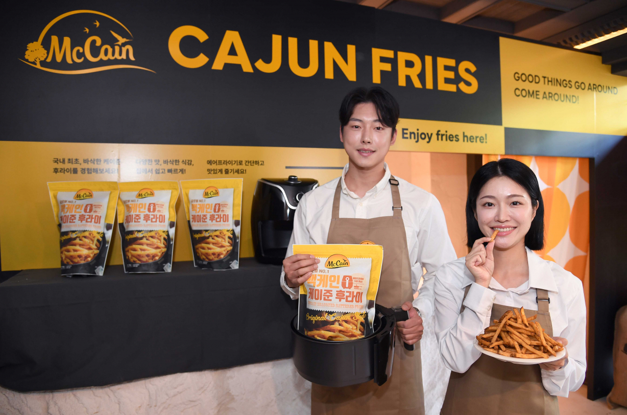 14일 서울 마포구 연남동에 오픈한 팝업 ‘하우스 오브 맥케인’ 시식 부스에서 모델들이 맥케인의 대표제품인 케이준 후라이를 시식하고 있다. [맥케인 제공]