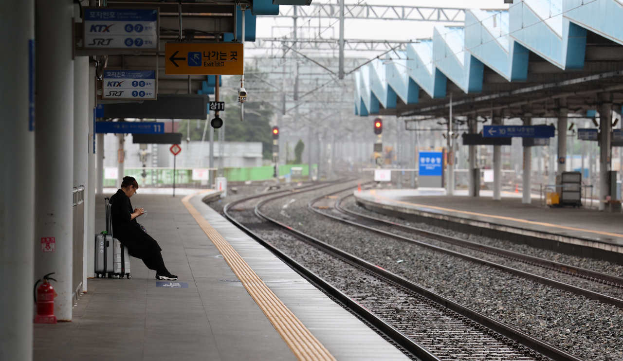 A passenger waits for a train at Gwangju Songjeong Station in the southwestern city of Gwangju on Friday, the second day of a four-day strike by rail workers. (Yonhap)