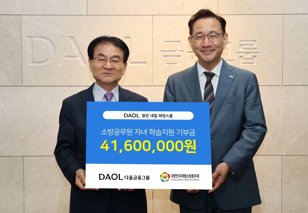 지난 25일 서울 영등포구 다올금융그룹 본사에서 김태우(오른쪽) 다올금융그룹 ESG위원장이 김철종 대한민국재향소방동우회 상임고문에게 소방공무원 자녀를 위한 기부금을 전달한 뒤 기념 촬영을 하고 있다. [다올금융그룹]