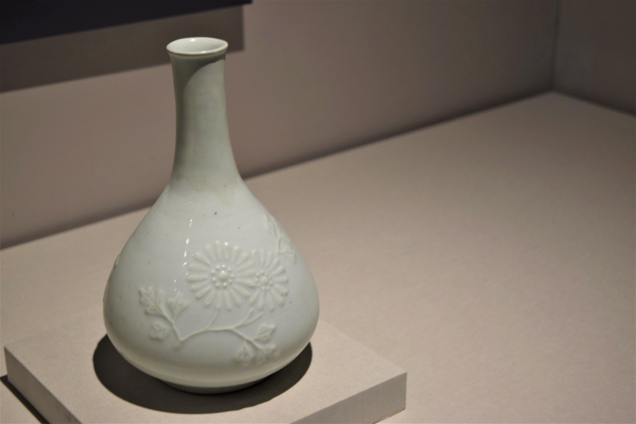 19th-century white porcelain bottle with chrysanthemum relief which symbolizes the well-being and health of its owner (Kim Hae-yeon/ The Korea Herald)