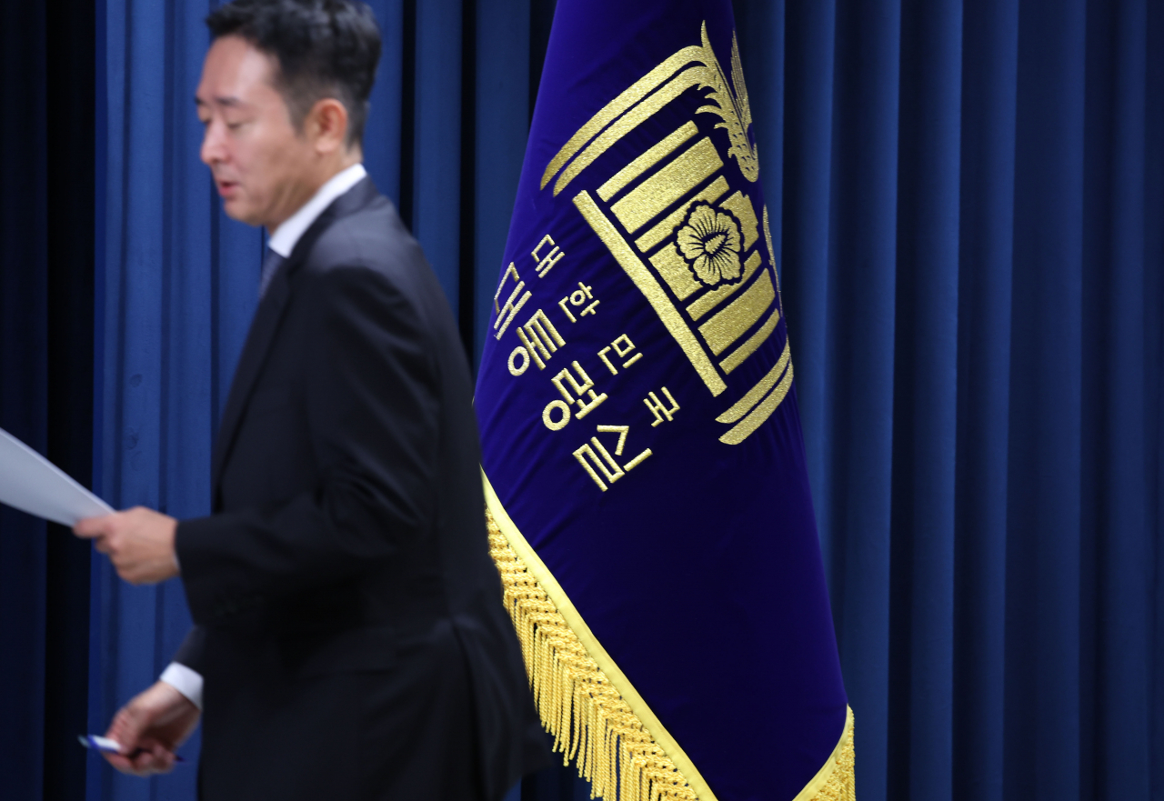 이도운 대통령실 대변인이 3일 서울 용산 대통령실 청사에서 현안 브리핑을 준비하며 대통령실 깃발 앞을 지나가고 있다. 연합뉴스