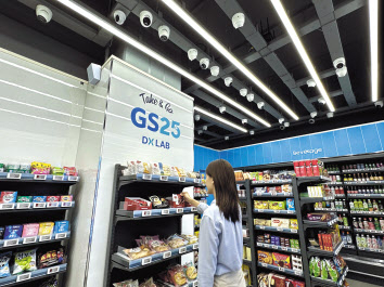 한 고객이 최첨단 리테일 테크가 총 망라된 GS25 DX LAB 가산스마트점에서 상품을 고르고 있다. [GS25 제공]