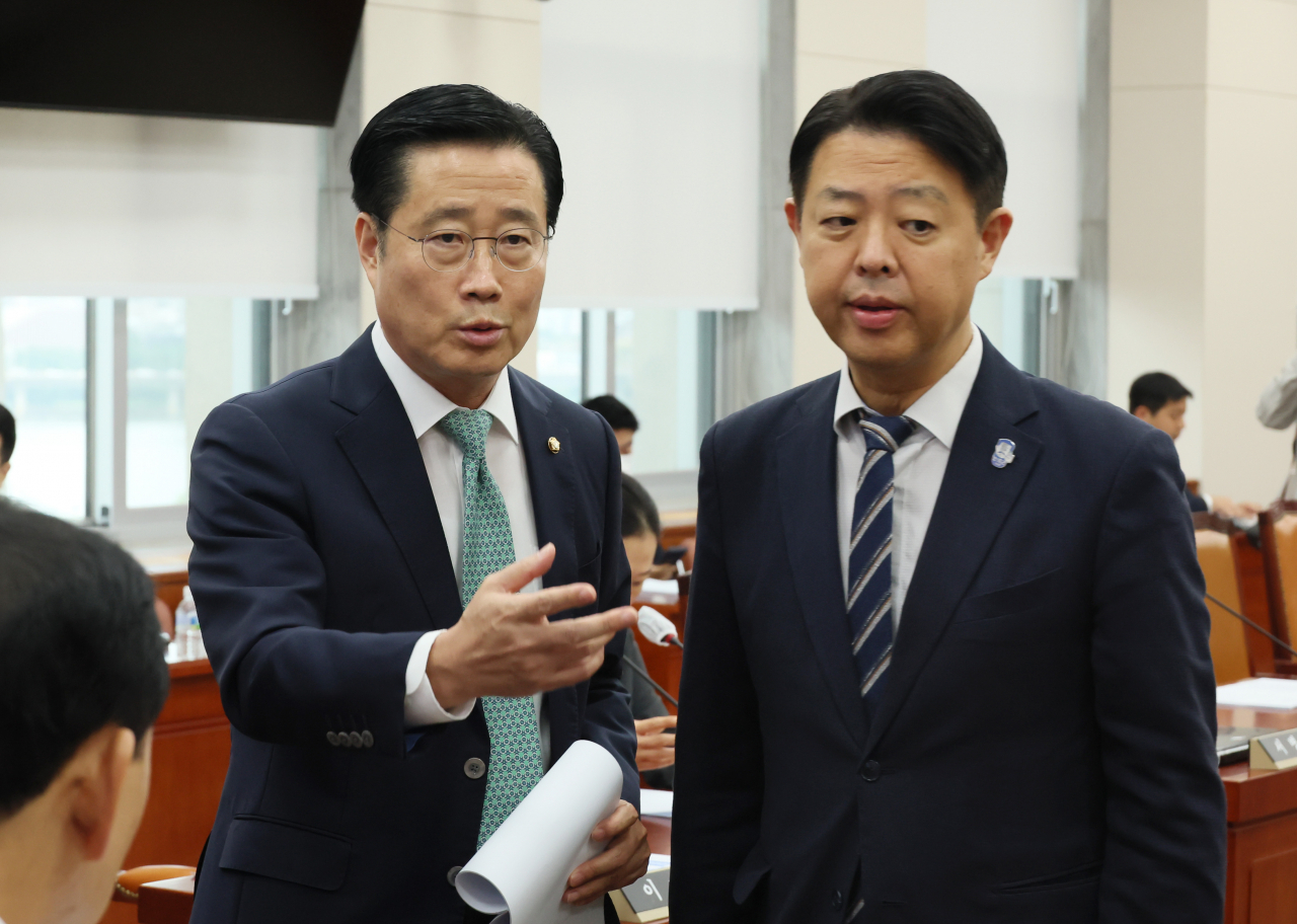 15일 국회에서 열린 교육위원회 전체회의에서 여야 간사인 이태규(왼쪽) 국민의힘 의원과 더불어민주당 김영호 의원이 대화하고 있다. 연합뉴스
