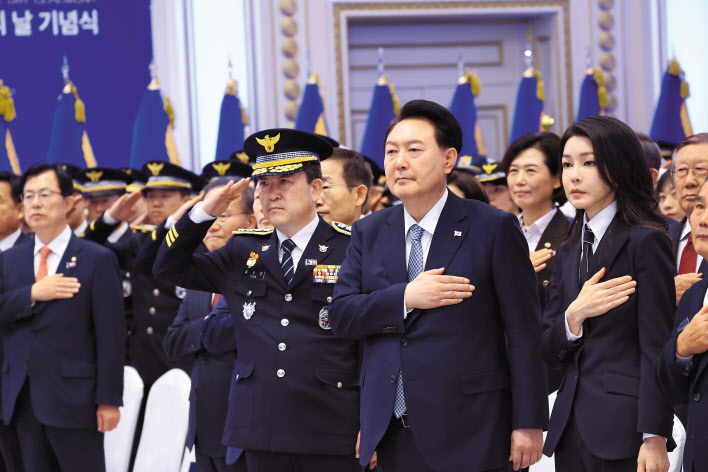 윤석열 대통령과 김건희 여사가 18일 청와대 영빈관에서 열린 제78주년 경찰의날 기념식에서 국기에 경례하고 있다. [연합]