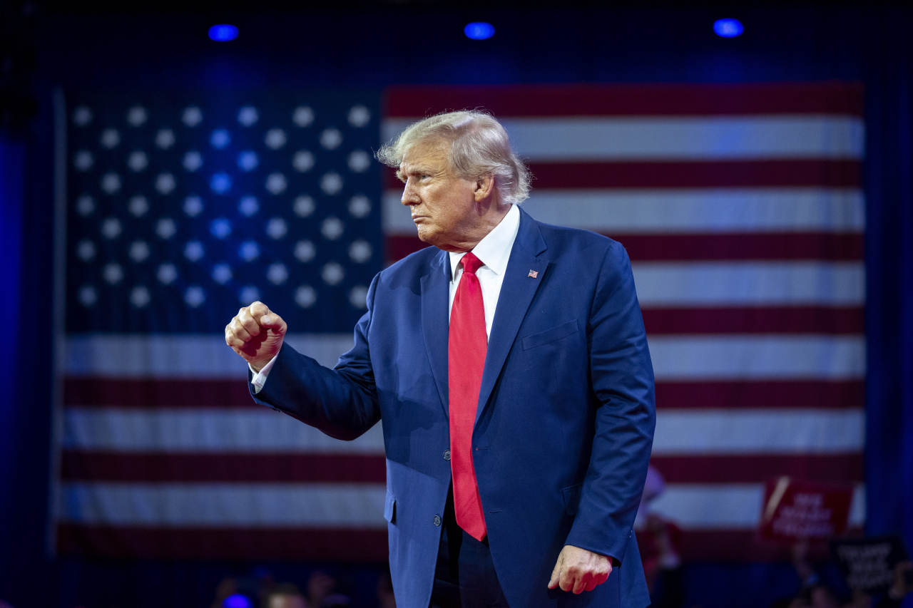 Former President Donald Trump pumps his fist as he departs after speaking at the Conservative Political Action Conference, CPAC 2023, on March 4 at National Harbor in Oxon Hill, Md. (AP-Yonhap)