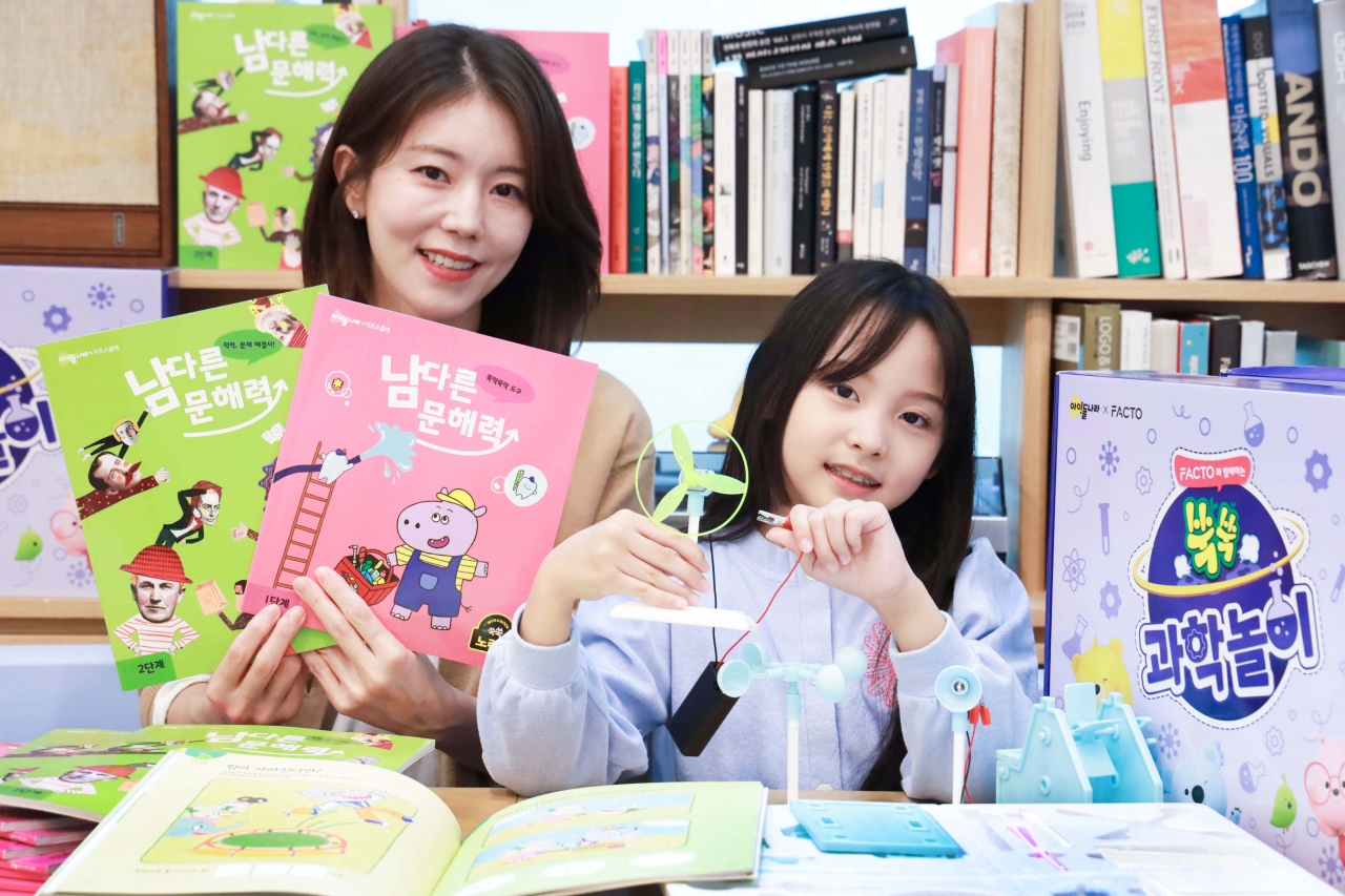 LG유플러스 모델이 아이들나라가 선보인 과학교구 키트와 문해력 교재 2종을 활용해 학습하고 있는 모습. [LG유플러스 제공]