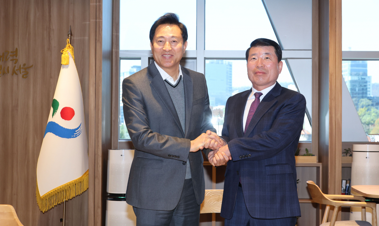 오세훈 서울시장과 백경현 구리시장이 13일 오전 서울시청에서 구리시의 서울시 편입 문제 등에 대해 논의하기 앞서 악수하고 있다.[연합]