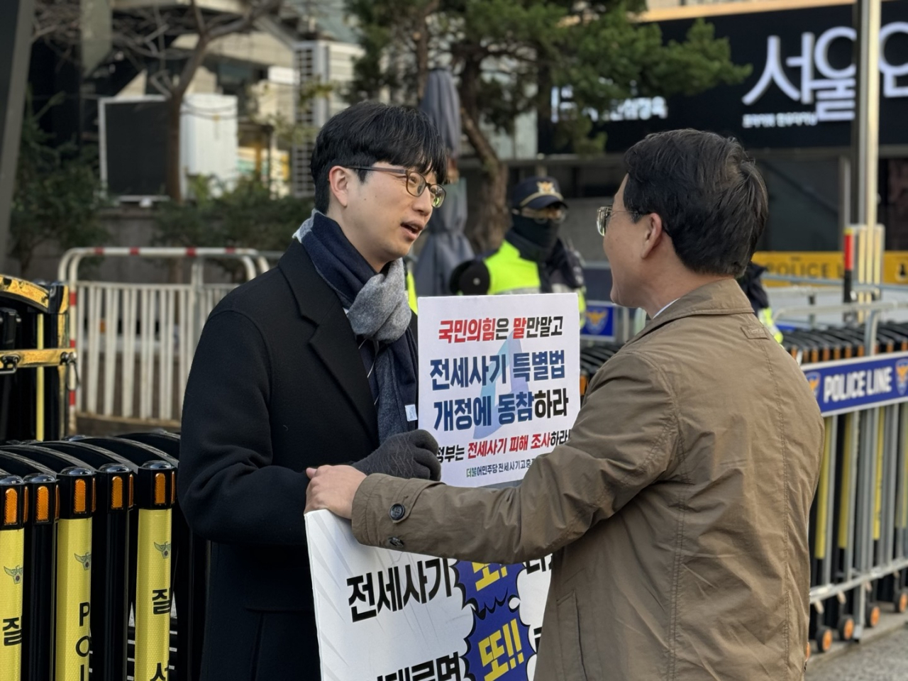 이원욱 더불어민주당 의원(오른쪽)이 21일 전세사기 특별법 개정을 요구하는 1인 시위 중인 권지웅 더불어민주당 전세사기고충접수 센터장을 찾아 격려하고 있다. 이세진 기자