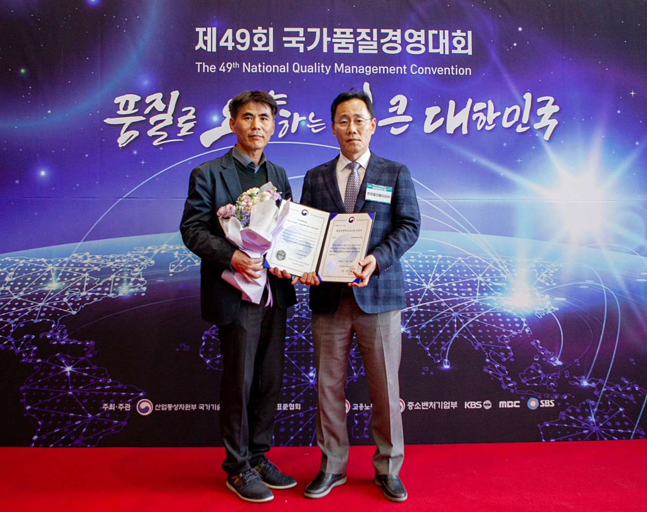 윤석용(오른쪽) 현대엘리베이터 CPO(최고제품책임자)와 박은제 품질담당이 22일 코엑스 오디토리움에서 열린 제49회 국가품질경영대회에서 기념 촬영을 하고 있다. [현대엘리베이터 제공]