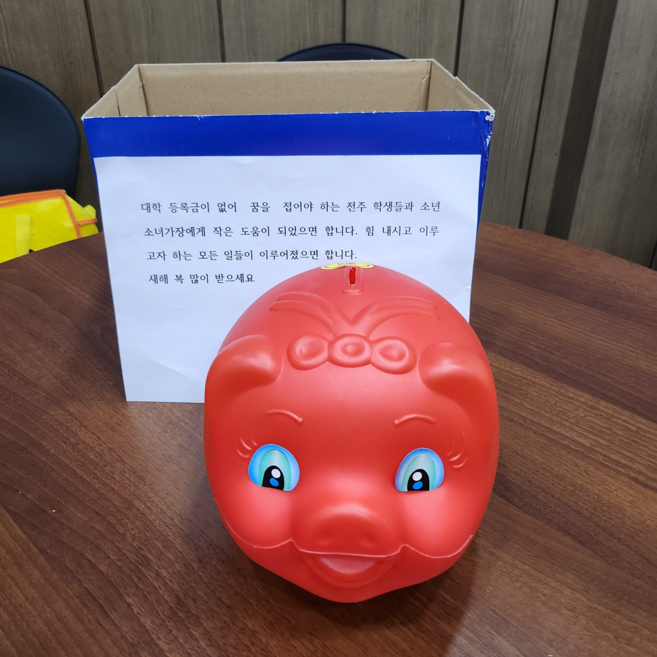 ‘얼굴 없는 천사’가 지난해 전주시 노송동주민센터에 전달한 돼지저금통과 메시지. [HD현대1%나눔재단 제공]