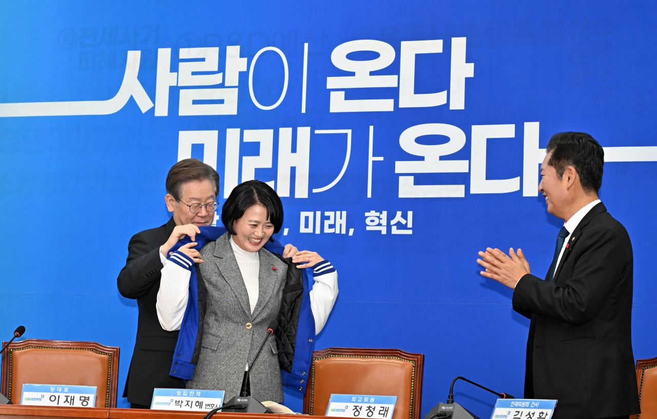 이재명(왼쪽) 더불어민주당 대표가 지난 11일 서울 여의도 국회에서 열린 인재영입식에서 영입인재 1호로 발탁된 박지혜 변호사에게 점퍼를 입혀주고 있다. 임세준 기자