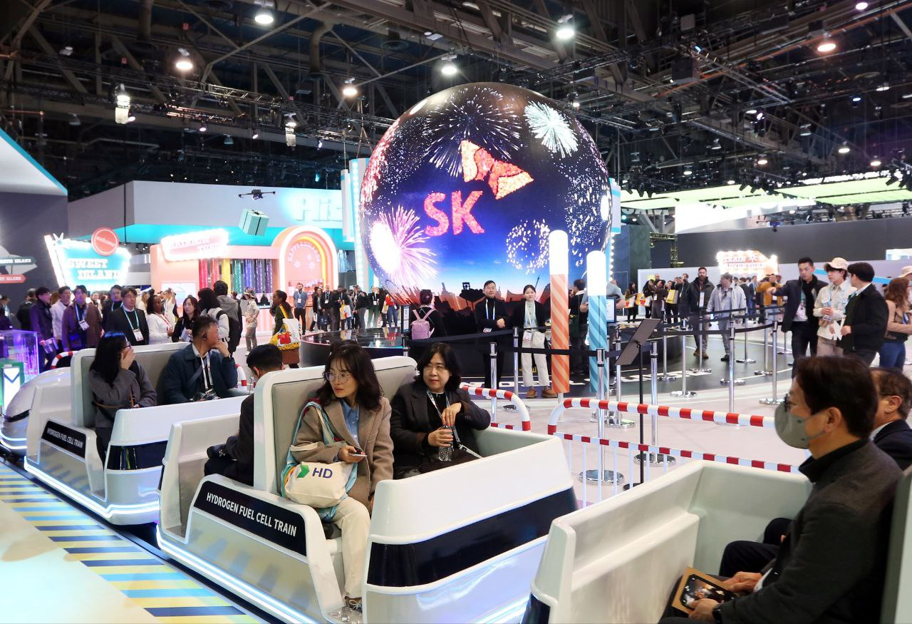 Visitors ride on “Train Adventure," a renewable energy-powered train at SK Group's showroom in Las Vegas Convention Center, the venue of the CES 2024. (SK Group)