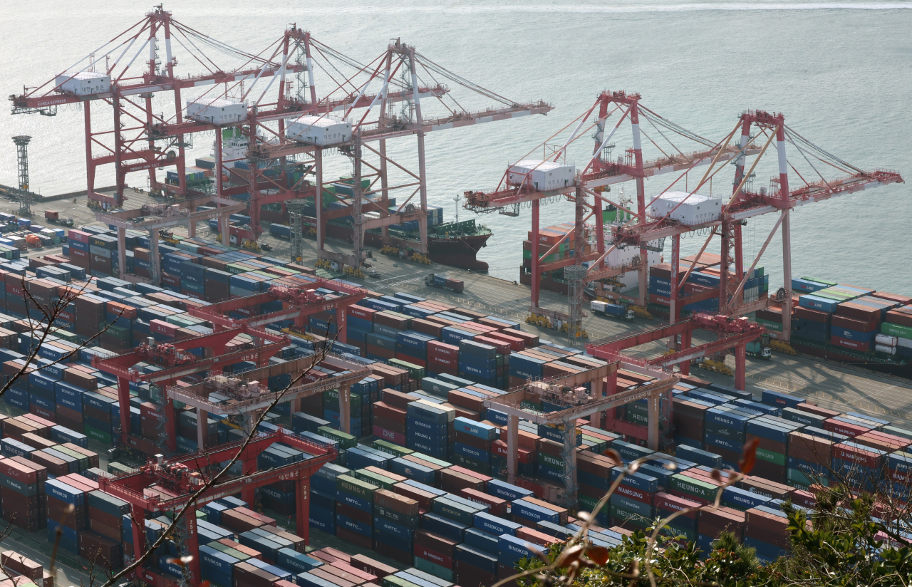 Containers for exports and imports are stacked at a pier in the southern port city of Busan on Jan. 1, 2024. (Yonhap)