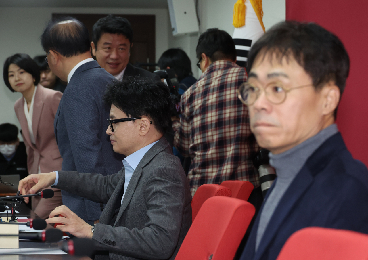 한동훈 국민의힘 비상대책위원장이 25일 여의도 당사에서 열린 비대위 회의에 입장해 착석하고 있다. 오른쪽은 김경율 비대위원. [연합]
